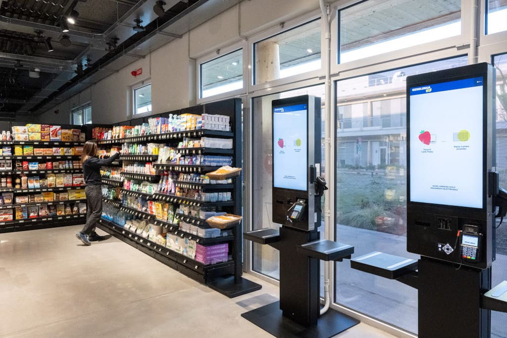 Shopper kontrollieren und bezahlen ihre im Grab & Go Store gewählten Waren an einem Self-Checkout-Terminal von Diebold Nixdorf (Foto: Esselunga)