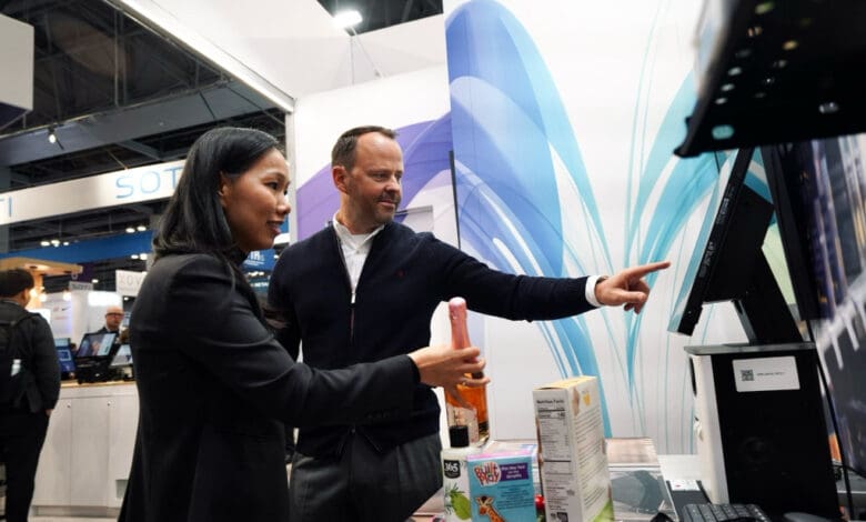 Trinh Le-Fiedler, CEO and Co-Founder of Nomitri, and Michael Scheibner, CEO at GK, mark the integration of Nomitri’s computer vision solutions into GK’s Cloud4Retail platform at NRF 2025. (Photo: GK Software)