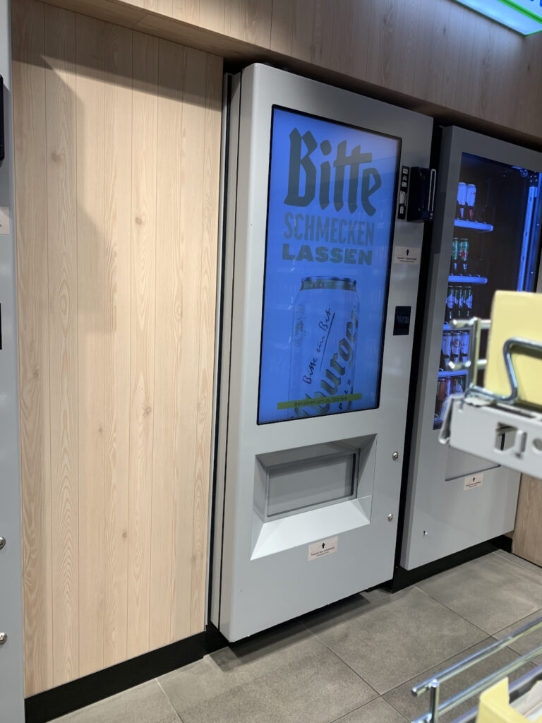 Customers only receive alcoholic products after successful age verification, so that the vending machine supports regulated sales in the same controlled environment as the tobacco system.
